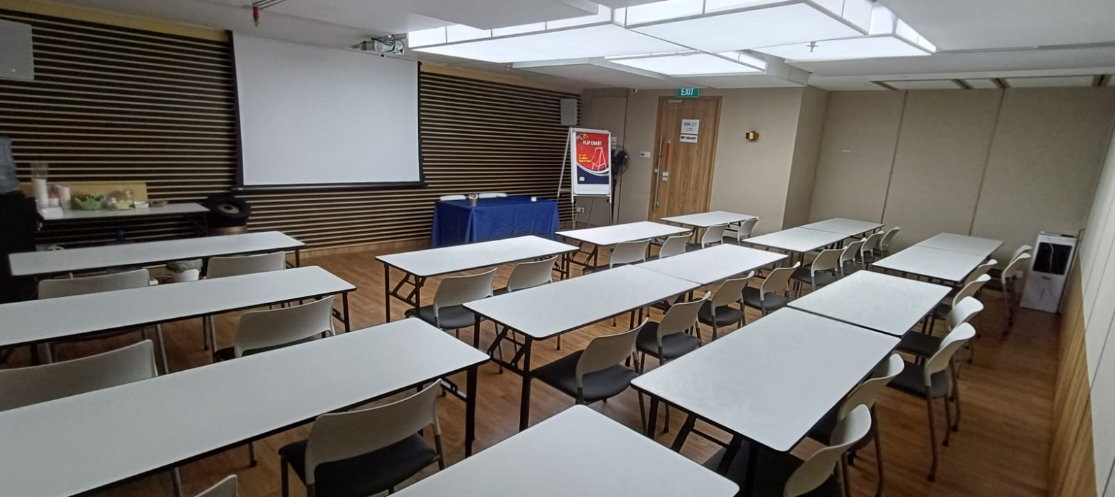 MIT Galaxy in classroom layout against a timber slat feature wall
